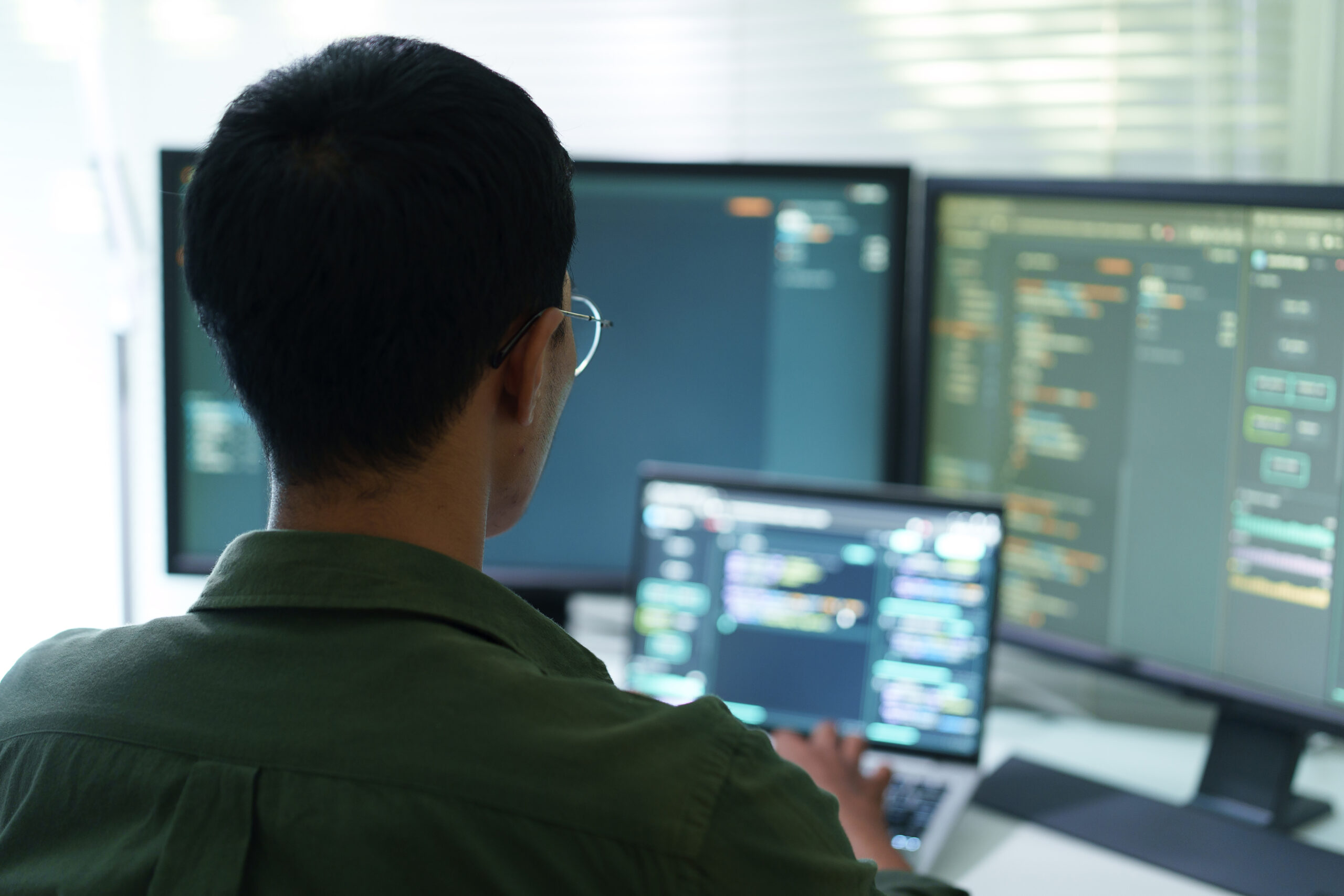 Técnico supervisando paneles de monitorización de una infraestructura cloud en una sala de operaciones